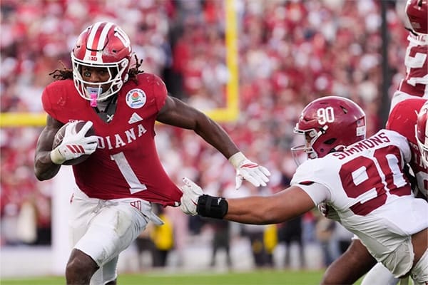 Alabama football player running with ball during Rose Bowl game illustrating talent versus culture