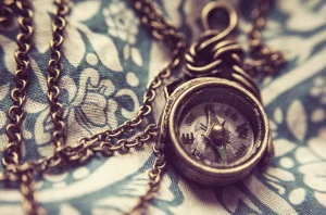 An antique pocket compass on a chain