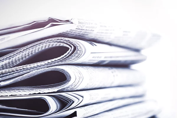 Stopped reading the news: a stack of folded newspapers