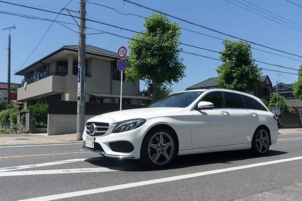 Ordinary life: a white car parked in front of a suburban house